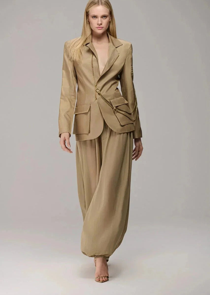 Woman wearing a beige suit on a plain background