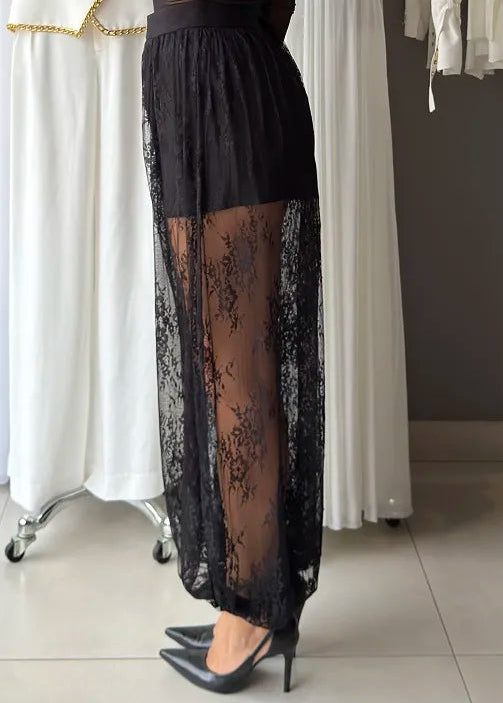 Woman wearing a black lace pants in a clothing store.