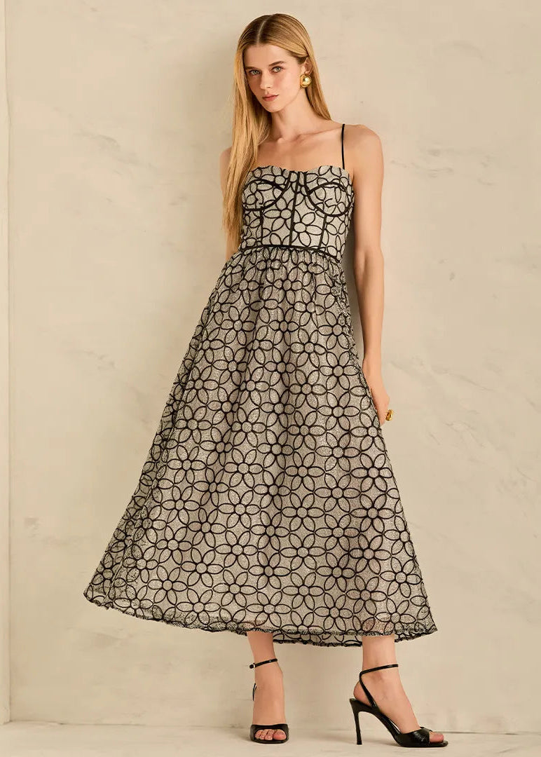 Woman wearing a black floral patterned dress 