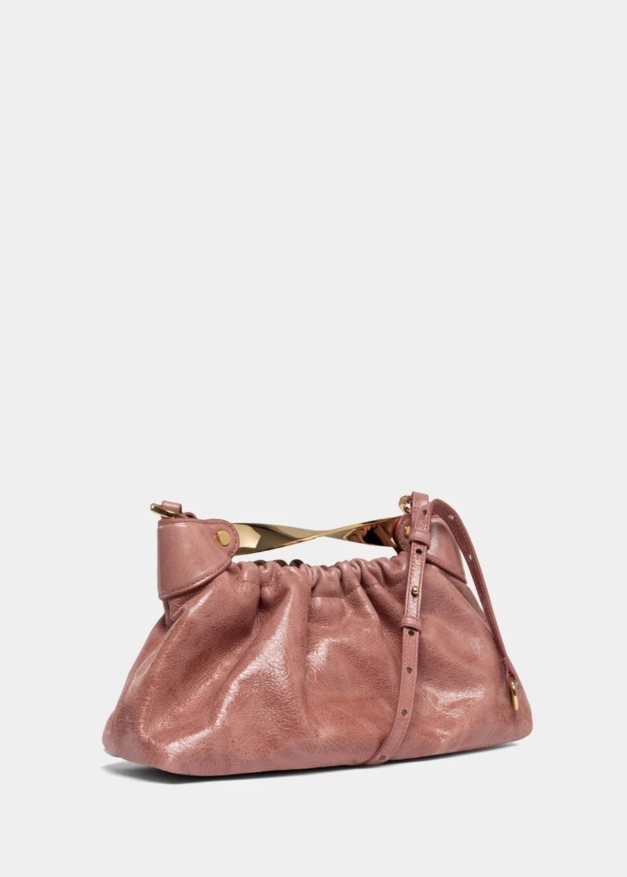 Pink handbag with gold accents on a white background