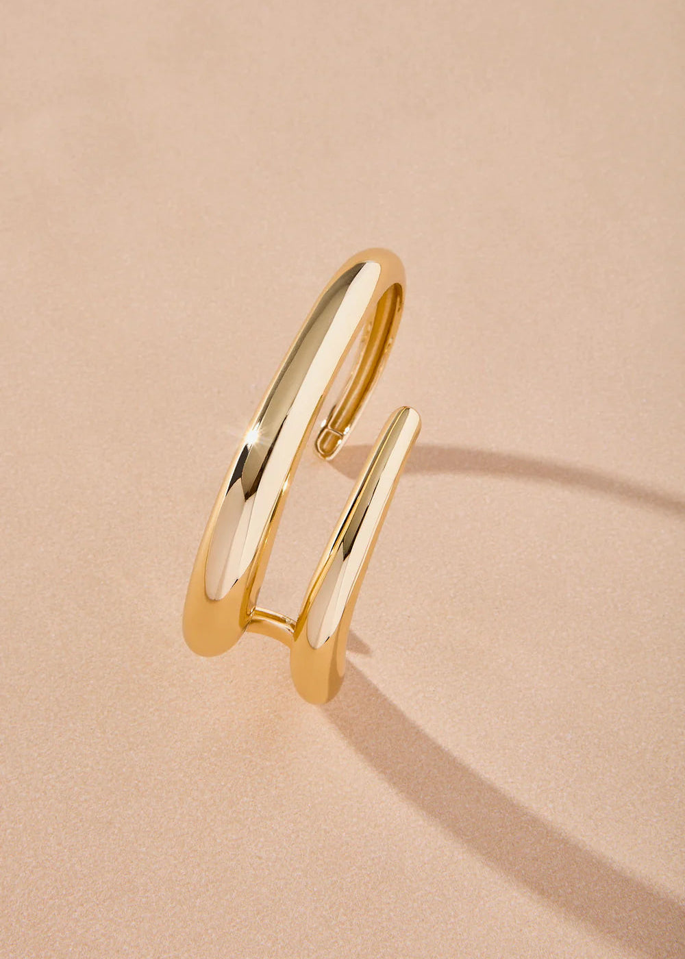 Gold ring on a beige background
