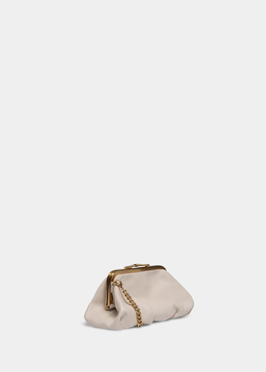 A small cream-colored leather clutch bag with a gold-tone metal frame and a gold chain strap, set against a solid light gray background.