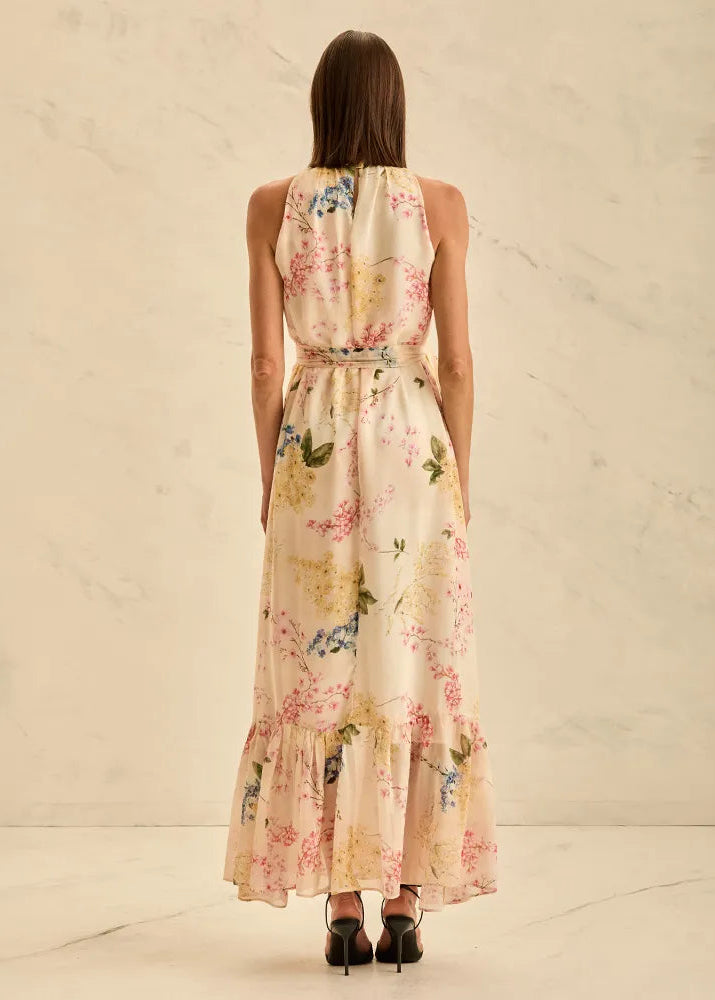 Woman wearing a floral dress with a neutral background