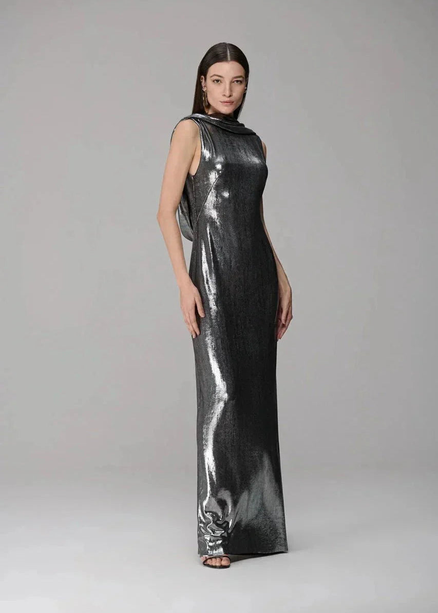 Woman wearing a metallic silver dress on a gray background