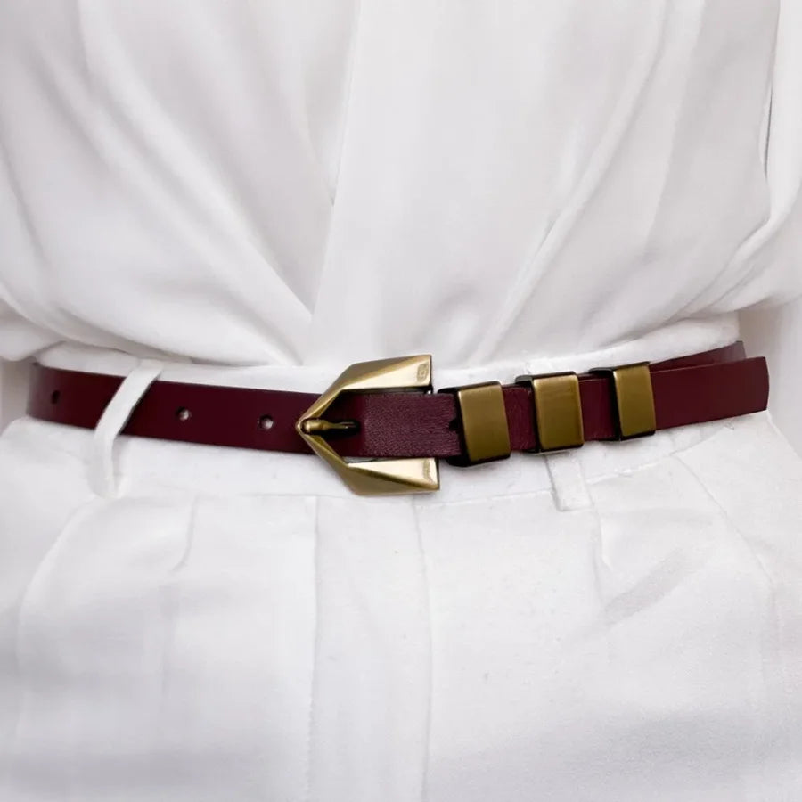 Maroon belt with gold buckle on a white outfit