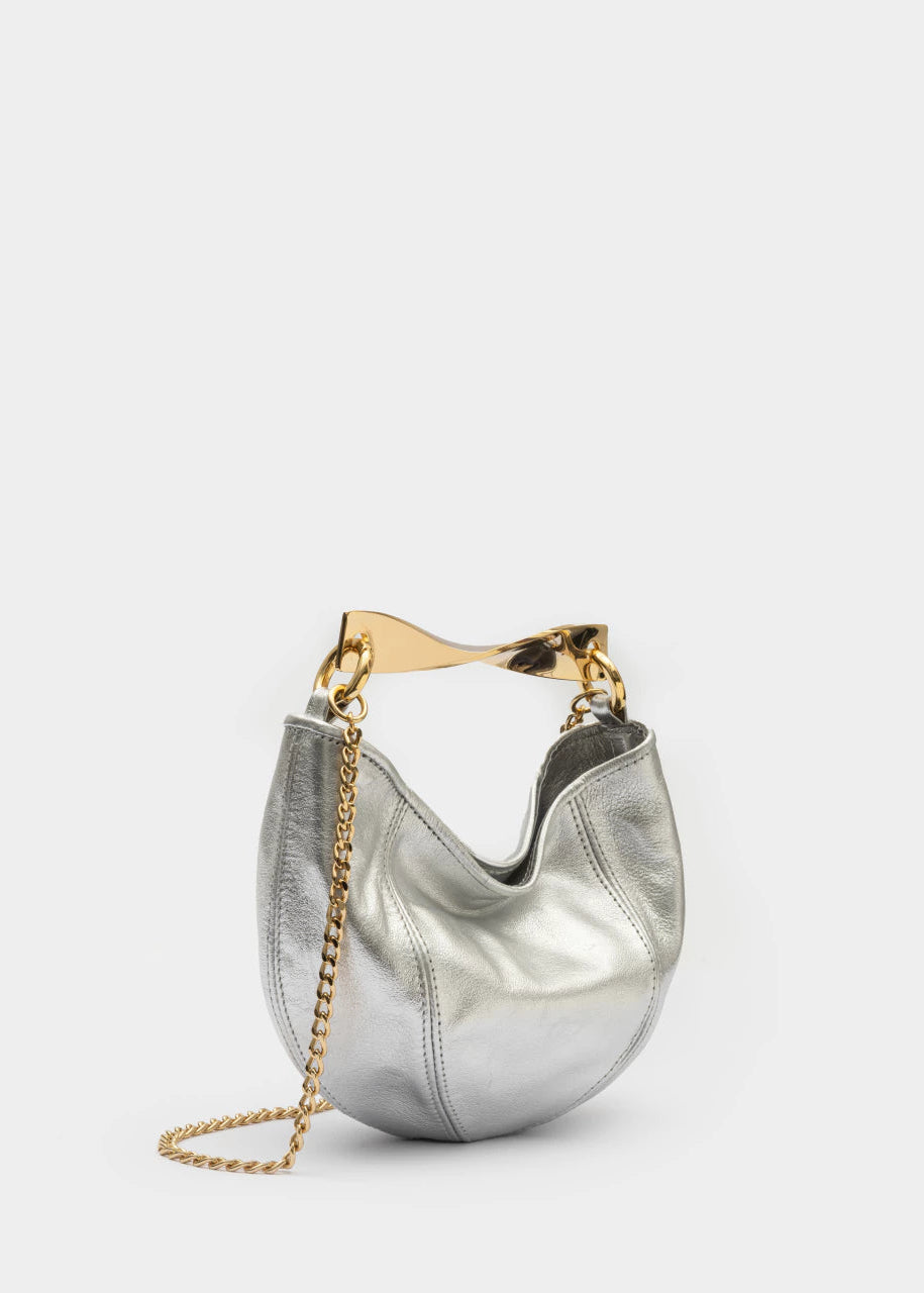 Silver handbag with gold chain and handle on a white background