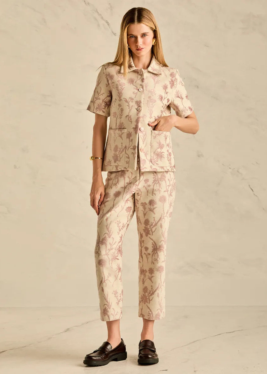 Woman wearing a floral outfit on a plain background